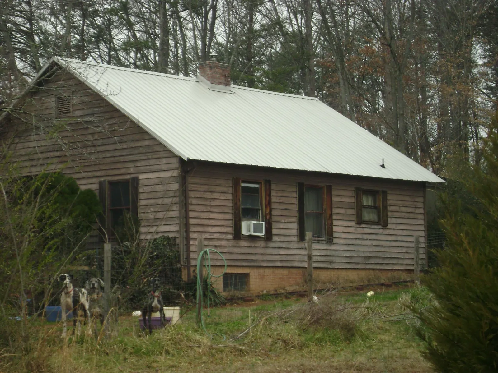 White metal roof on an old wood sided farmhouse, from a Metal Roof Installation job in Templeton